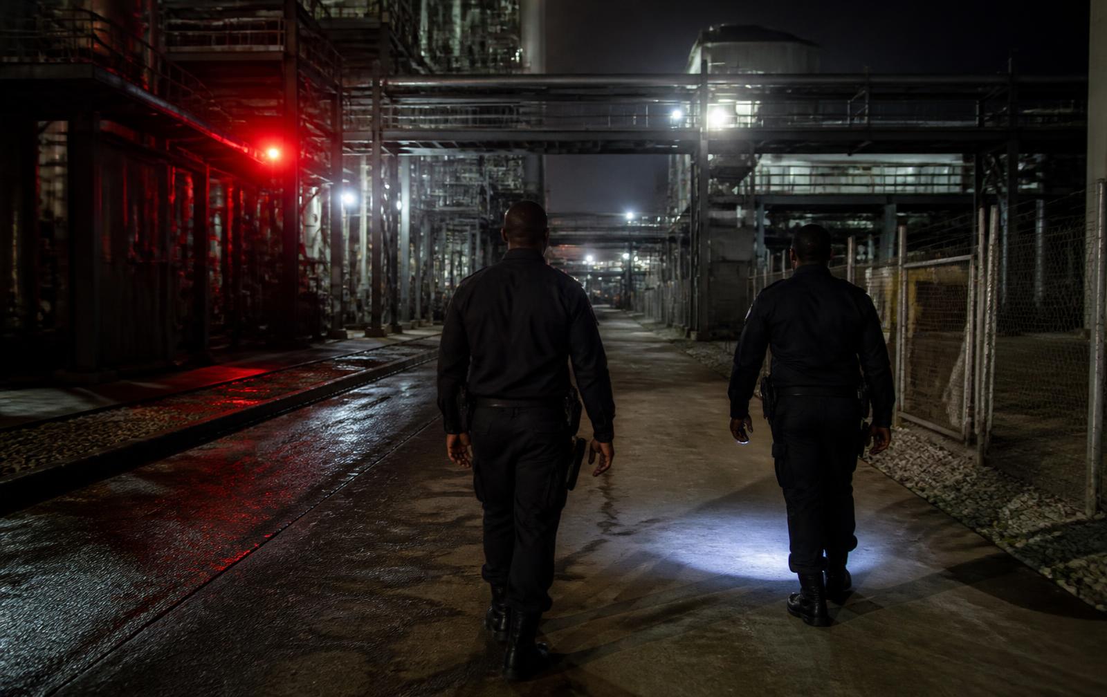 Warhawk security officer monitoring a manufacturing plant gate